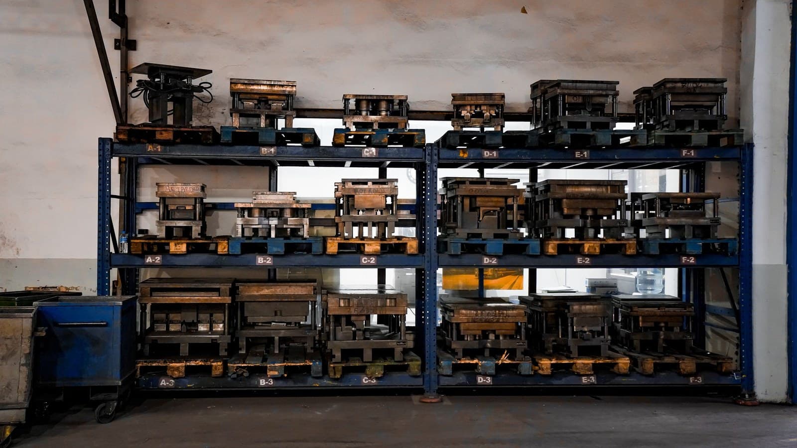 A packing line in a plant: workers at long benches wrapping finished goods.